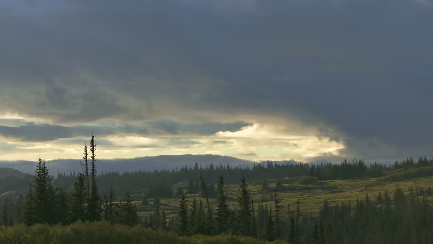 Clouds moving and morphing over an Alaskan landscape in time lapse.
