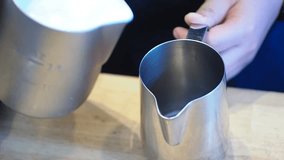 Coffee maker pour milk in stainless jug.High quality coffee clip video.
