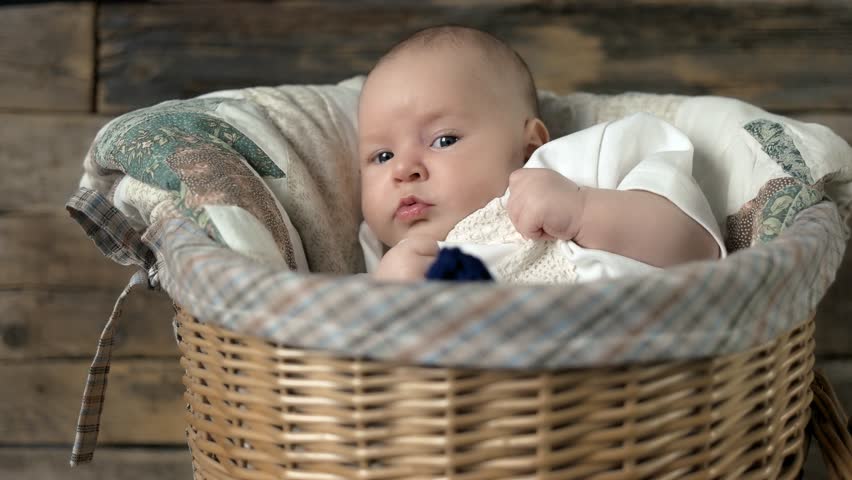 Basket with a baby. Look of a child. Our hope and our future.