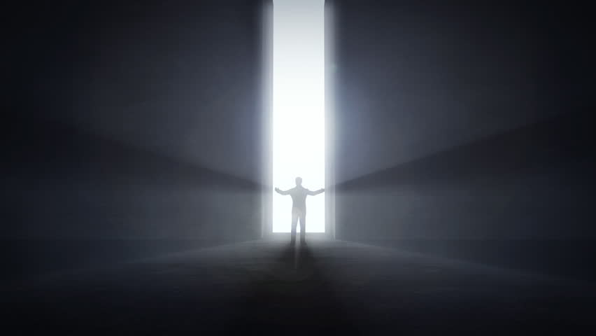Businessman standing in the front of an opening light tunnel, opportunity concept