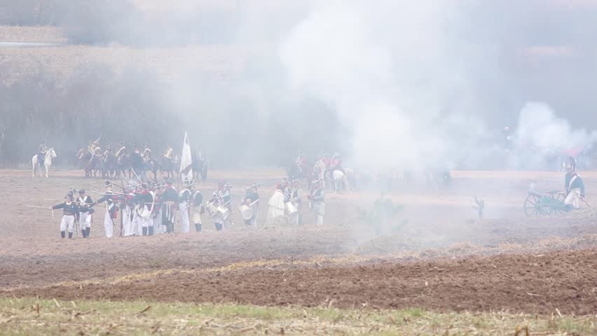 Reconstruction of the battle of 1812 between Russian and French troops, there is a battle, explosions and smoke from the shots of cannons