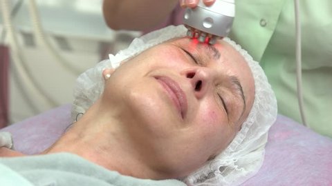 Mature female, rf skin tightening. Face of adult woman, cosmetology. Radio frequency treatment facts.