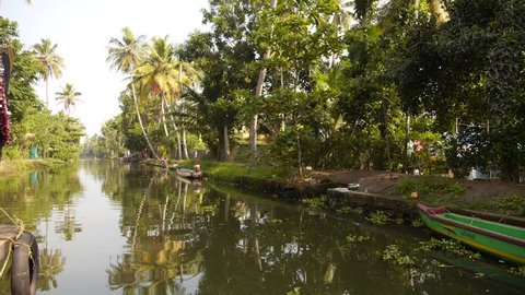 View from a moving houseboat on a canal in the backwaters of Alleppey in the State of Kerala, Southern  India
