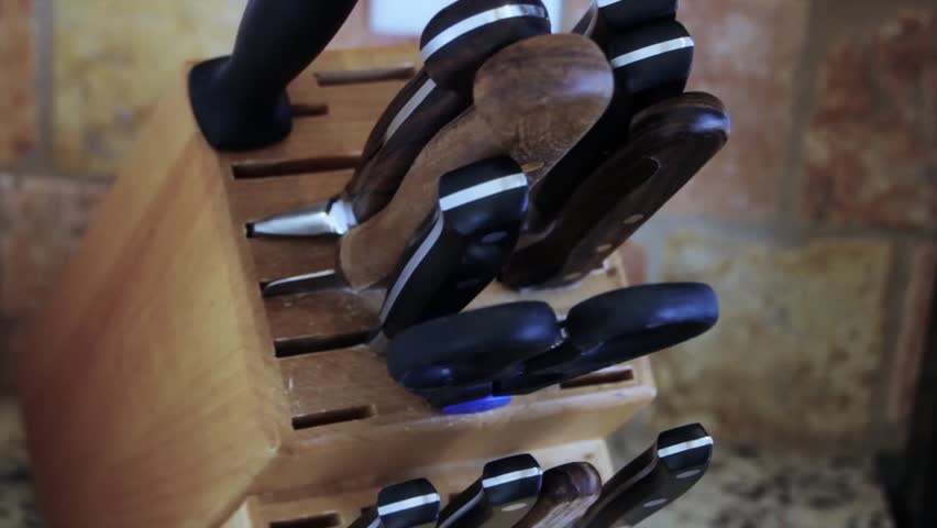 Man uses knives from a knife block