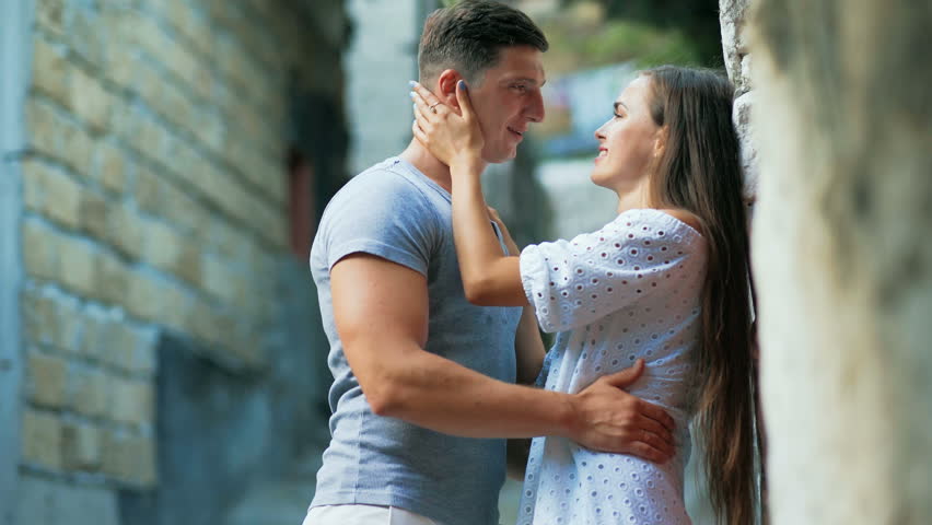 Young couple in love, hugging in the old part of town