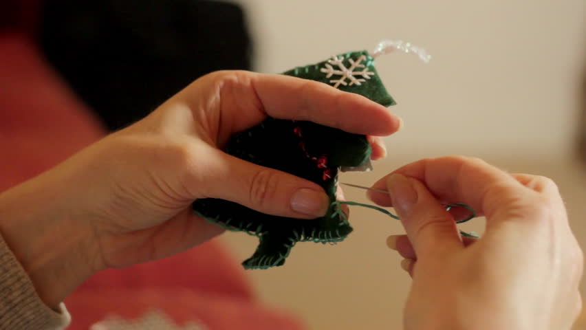 Woman hand sewing christmas decorations