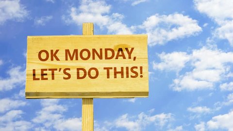Ok Monday, let's do this! Words on a wooden sign against time lapse clouds in the blue sky.