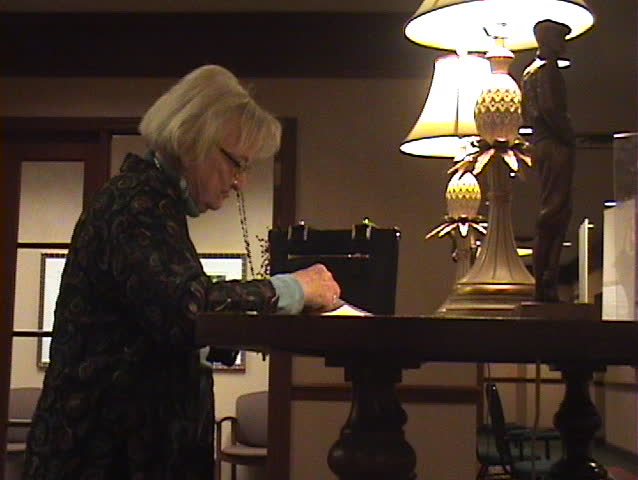 Senior Citizen opening mail in Retirement Community