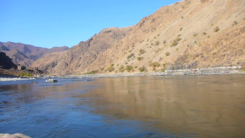 Point of view of person putting on snorkel mask then jumping into Snake River in