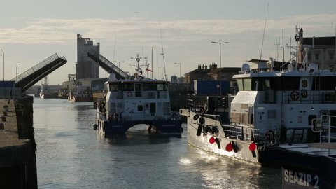 Lowestoft, England - September 2017. Bridge opening with a queue of Wind Farm Support Vessels returning home, waiting to pass through the bascule bridge and Harbour, Suffolk, England, United Kingdom