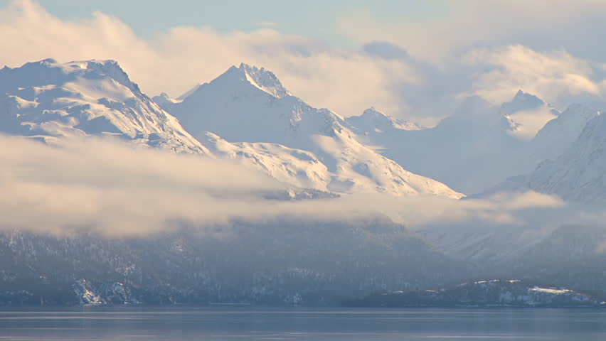 Time lapse clouds glowing over the Kenai Mountains as seen from the bluff in