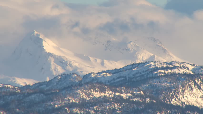 Stunning imagery of fresh snow and clouds on peaks of the Kenai range that form