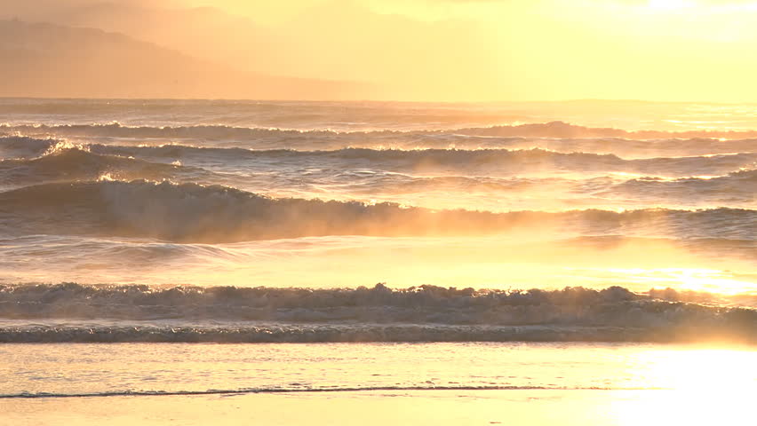 Resplendent and beautiful, the sun casts golden light over the waves of Kachemak