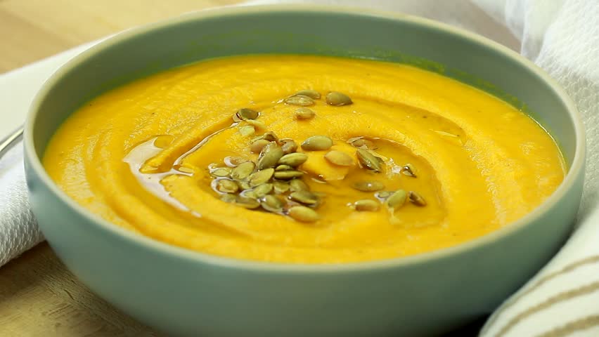 A gourmet pumpkin cream butternut squash Orange soup with seeds seasoning Royalty-Free Stock Footage #31103242