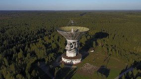 4K high quality aerial drone video of observatory's parabolic reflector 64 m in diameter radio telescope in forest near Tolstouhovo village, town Kalyazin 200 km north of Moscow, Russia on summer day