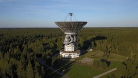 4K high quality aerial drone video of observatory's parabolic reflector 64 m in diameter radio telescope in forest near Tolstouhovo village, town Kalyazin 200 km north of Moscow, Russia on summer day