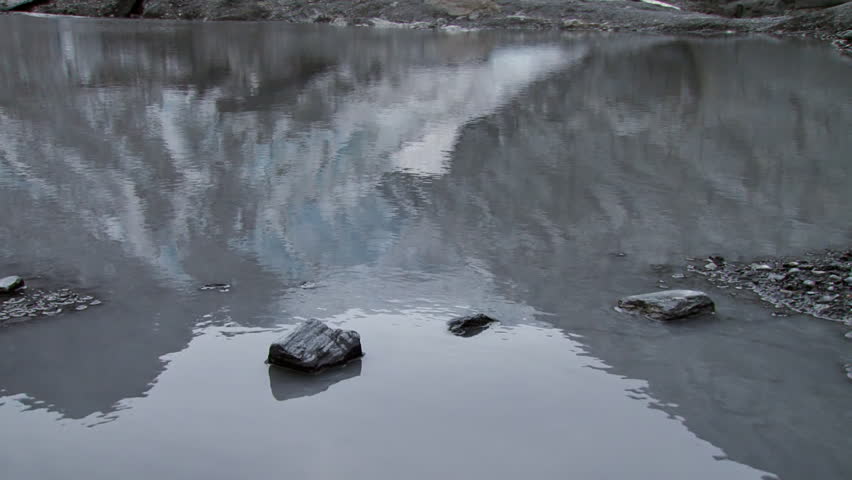 Reflection of the nose of Worthington Glacier in a meltwater pool.