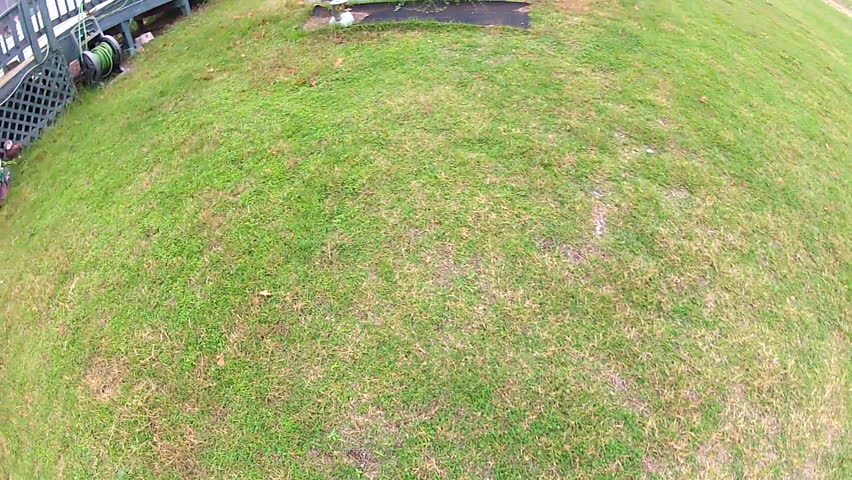 The point of view of a man hurriedly entering a storm or tornado shelter on a cloudy day in Oklahoma.