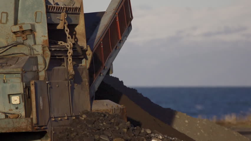 Close shot of a vibrating grizzly (rock/ore separator) being used to grade rocks