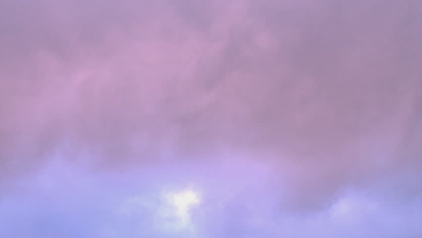 Rose-lavender hued clouds moving to darker, more sullen greys and blacks as the