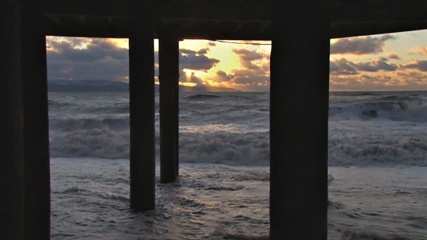 Roiling Breakers Storm Surge Under Pilings Sunset
