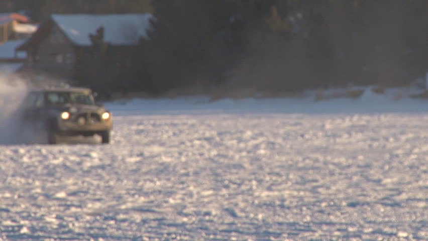 Young fellow learning winter driving skills by horsing around on a frozen lake.