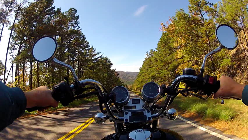 A wide angle point of view shot from a chest mounted camera on a motorcyclist