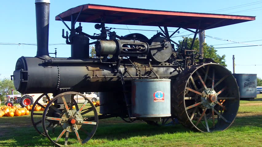 An historic tractor, powered by steam on display in a park in the small town of