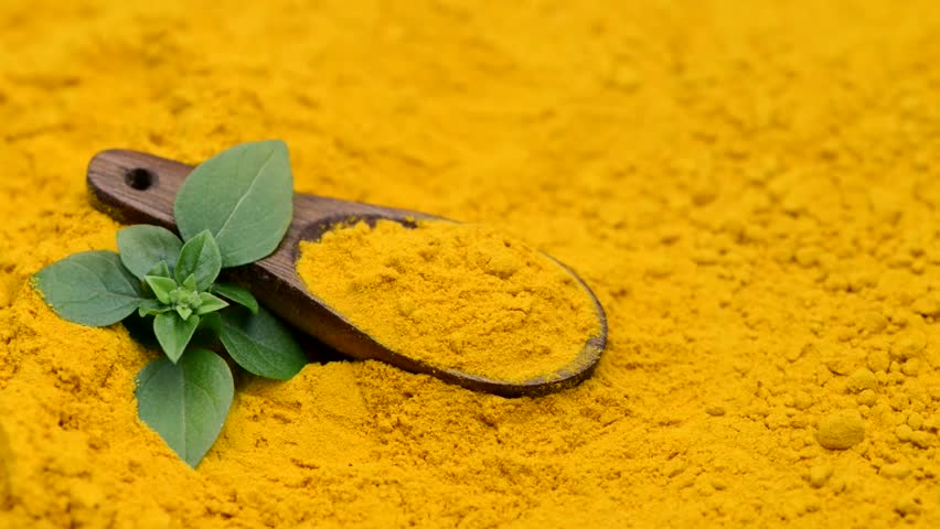 powdered background of turmeric with a wooden spoon on a turn table with greenery  Royalty-Free Stock Footage #31126870