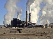 Video of closeup view of a coal burning electric generating power plant. View from desert road. Northern New Mexico near Farmington. In and around indian reservation. 