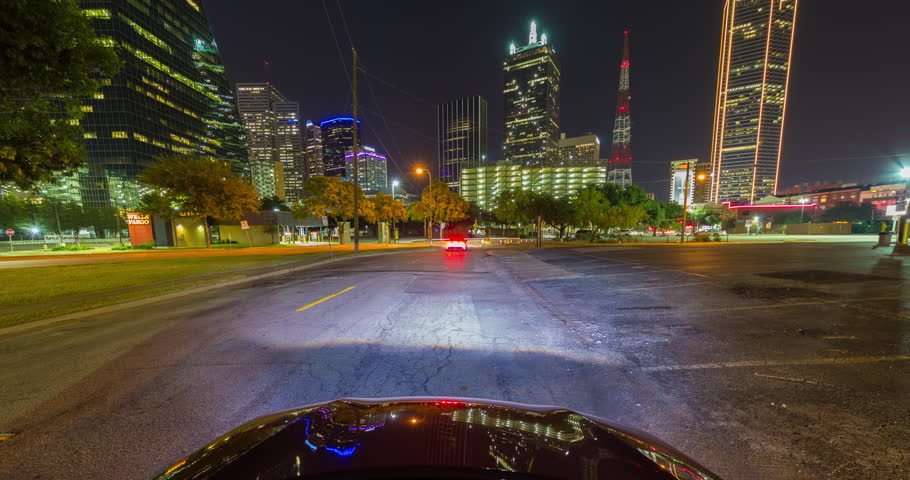 Vehicle Driving at Night in Downtown Dallas Time-lapse. a time-lapse view of the front of a vehicle traveling through downtown Dallas texas at night
