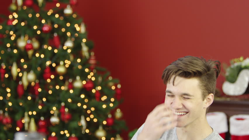 Young man using digital tablet, christmas day.