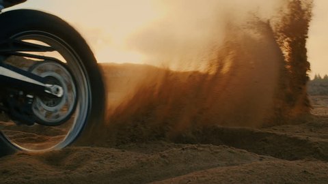 Professional Motocross Motorcycle Rider Drives on the Off-Road Sand Terrain. Shot on the Scenic Quarry with Setting Sun. Shot on RED EPIC-W 8K Helium Cinema Camera.