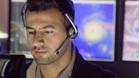 Meteorologist monitoring hurricane activity on his computer