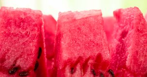 Slices of Watermelon on the Bright Background. Video Loops. Triangular Pieces rotate in front of the camera on a bright juicy background