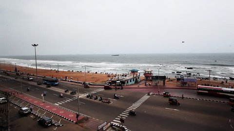 Pan shot of traffic moving on the Beach Road at Ramakrishna Beach, Visakhapatnam, Andhra Pradesh, India