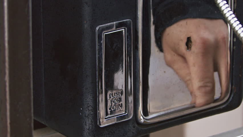 Retrieving coins out of a pay phone's coin return slot after a call was ended.