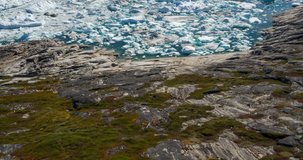Arctic nature landscape with icebergs in Greenland icefjord. Aerial drone footage video of ice and iceberg. Ilulissat Icefjord with icebergs from Jakobshavn Glacier aka Sermeq Kujalleq glacier.