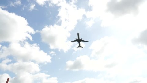 Looking Up at Airplane Taking off with Blue Skies Close Slow Motion