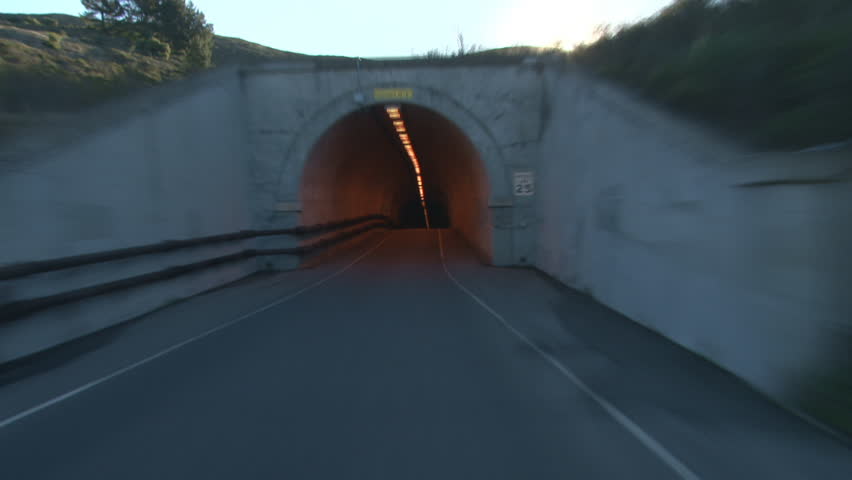 Driving first person POV shot through single lane tunnel under Hawk Hill at
