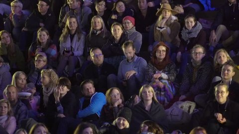 HELSINKI, FINLAND - SEPTEMBER 01, 2017: A lot of spectators in the movie theater outdoors in the evening. Outdoors cinema movies theater on the waterfront at night time