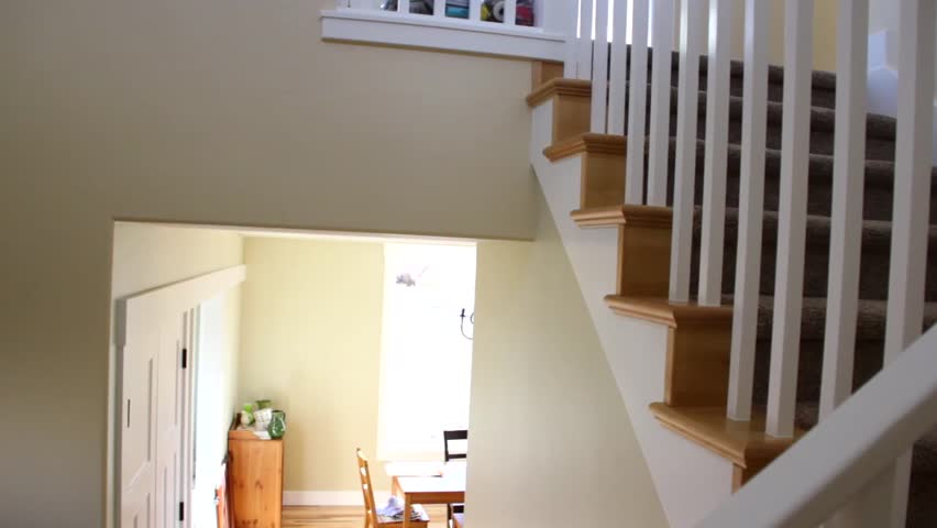 A dolly shot of carpeted stairs in a new home