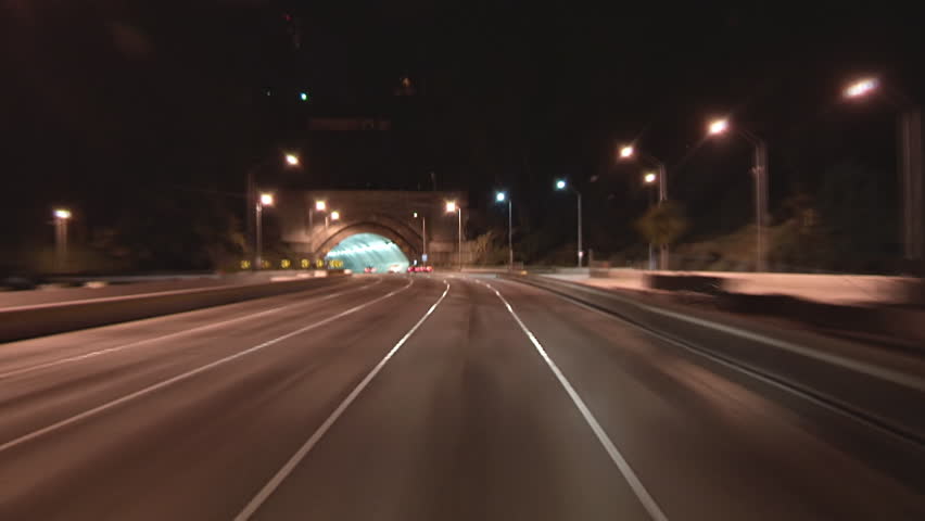 Driving POV freeway time lapse through Yerba Buena tunnel heading toward San