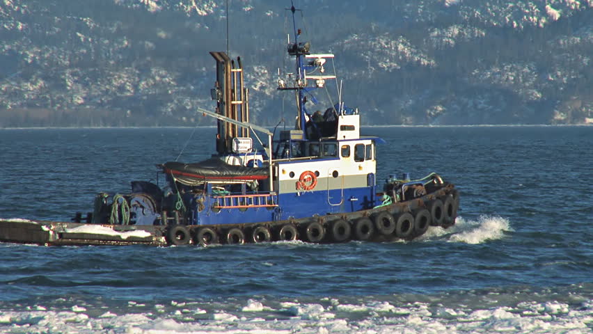Tugboat Redoubt leaving Homer's Small Boat Harbor, heading into Kachemak Bay in
