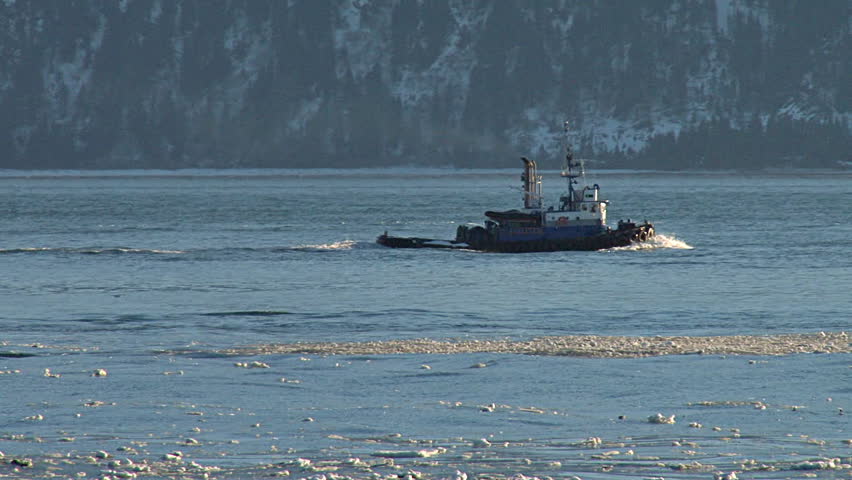 Tugboat Redoubt Under Way in Icy Waters