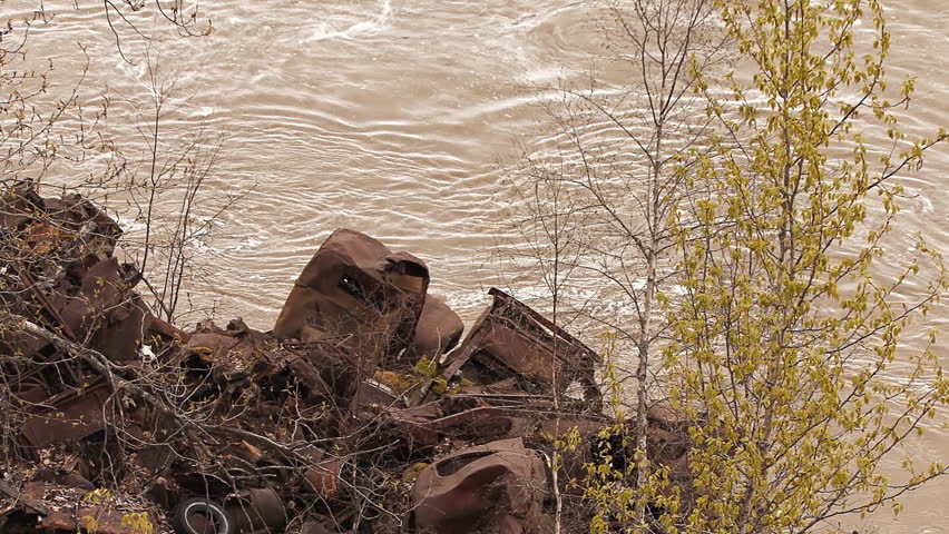 Twisted Wreckage Flooding Riverbank