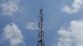 Video time lapse or timelapse of technology station connection, tower signal or antenna tower. Royalty high-quality free stock time lapse footage of tower signal in blue sky white clouds background