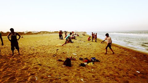 INDIA - JULY 2012: Pan shot of tourists enjoying  the beach, Chennai, Tamil Nadu, India