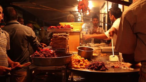 INDIA - JULY 2012: Locked-on shot of a chefs preparing food, Khau Galli, Mumbai, Maharashtra, India