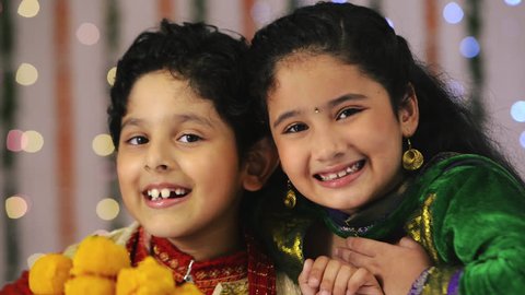 Locked-on shot of siblings smiling during Diwali festival